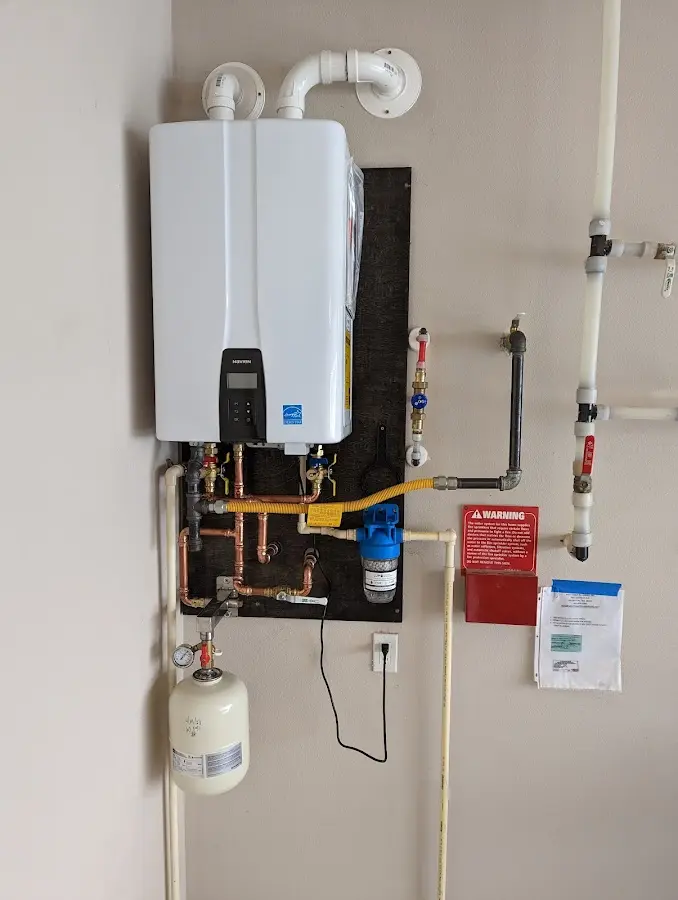 Professional plumber installing copper piping in a Lucas Valley-Marinwood home